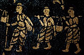 Wat Xieng Thong temple in Luang Prabang, Laos. Detail of the  intricate gold stencilling on black lacquer that decorate the walls of the sim. 